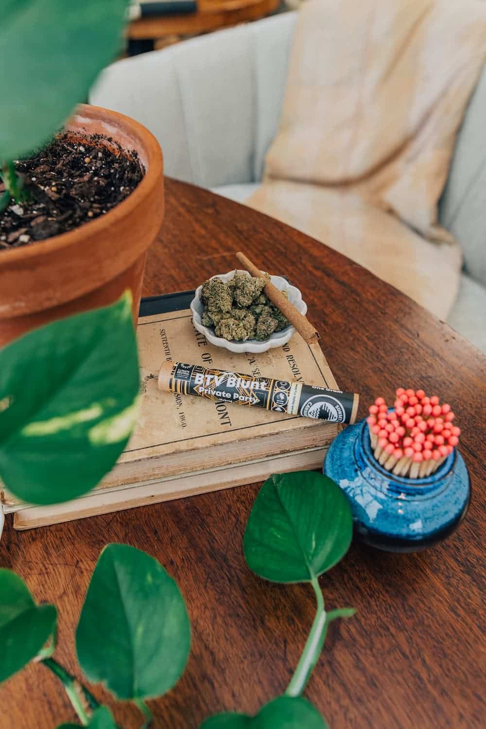 Photo of a Sunset Lake Cannabis "BTV Blunt" Private Party strain, sitting with a bowl of flower and a fancy pot of matches.