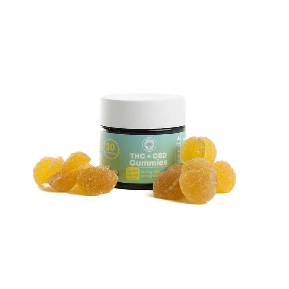 Photo of Sunset Lake Cannabis THC+CBD Gummies jar with some yellow sugar-coated gummies around the jar. Made with cannabis grown in South Hero, VT. Marijuana gummies are a great choice for those who don't want to smoke or vape.